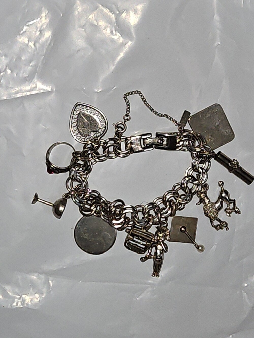 VINTAGE 1960s MONET SILVER TONE CHARM BRACELET WITH STERLING CHARMS.